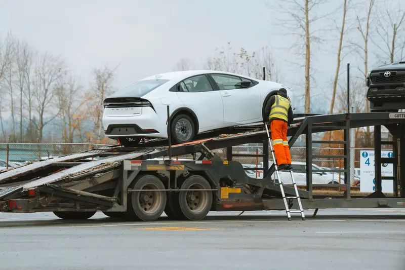 A car being loaded onto a transport truck