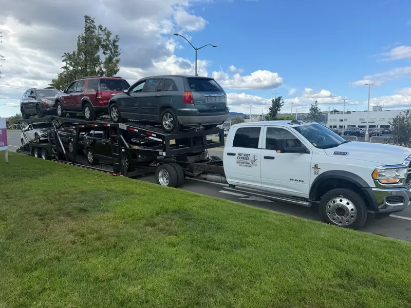 The Hotshot Express truck hauling five vehicles for a dealer move