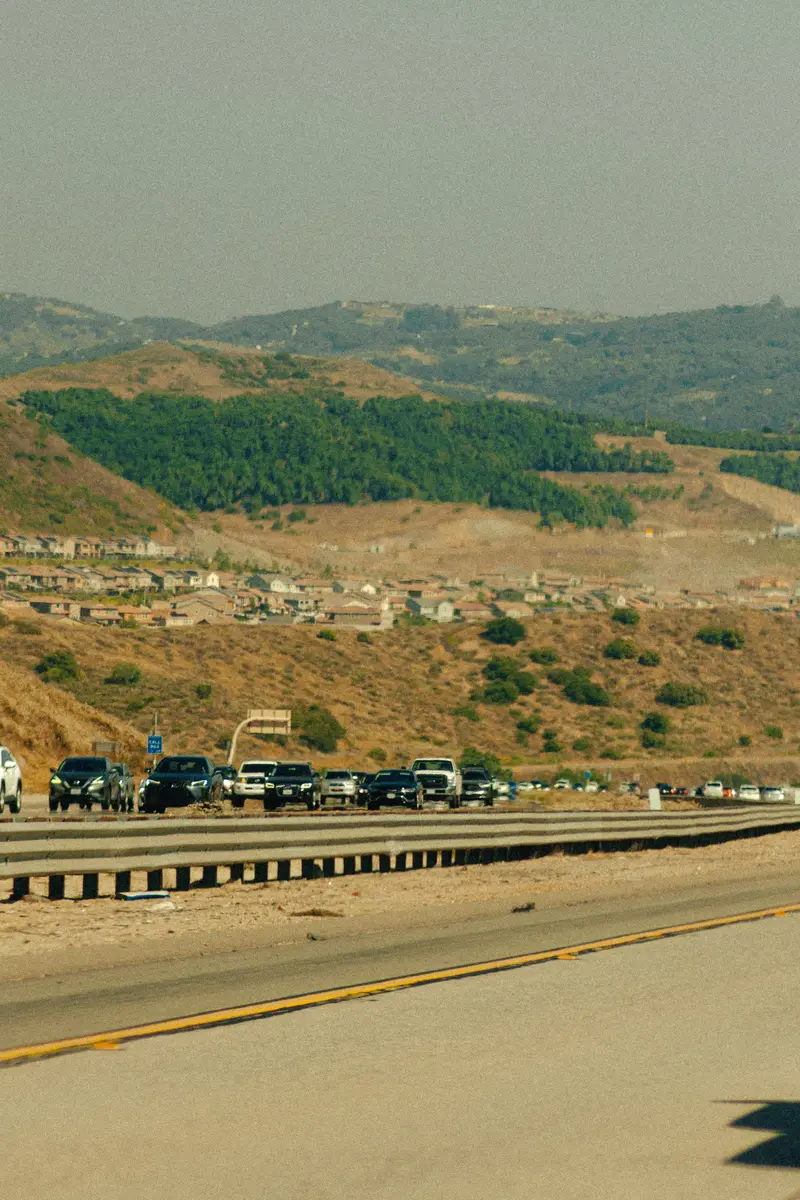 A California highway with traffic winding through the hills